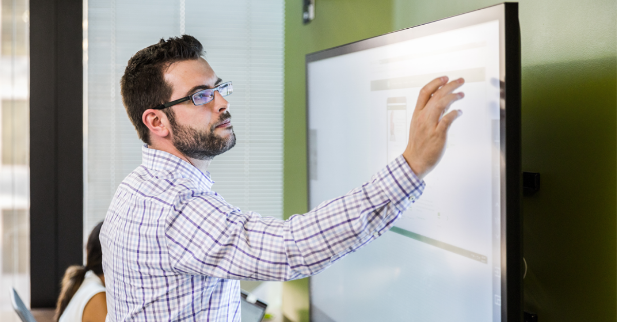 Man pointing to digital whiteboard