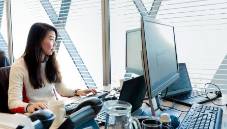 Woman sitting at computer in modern office
