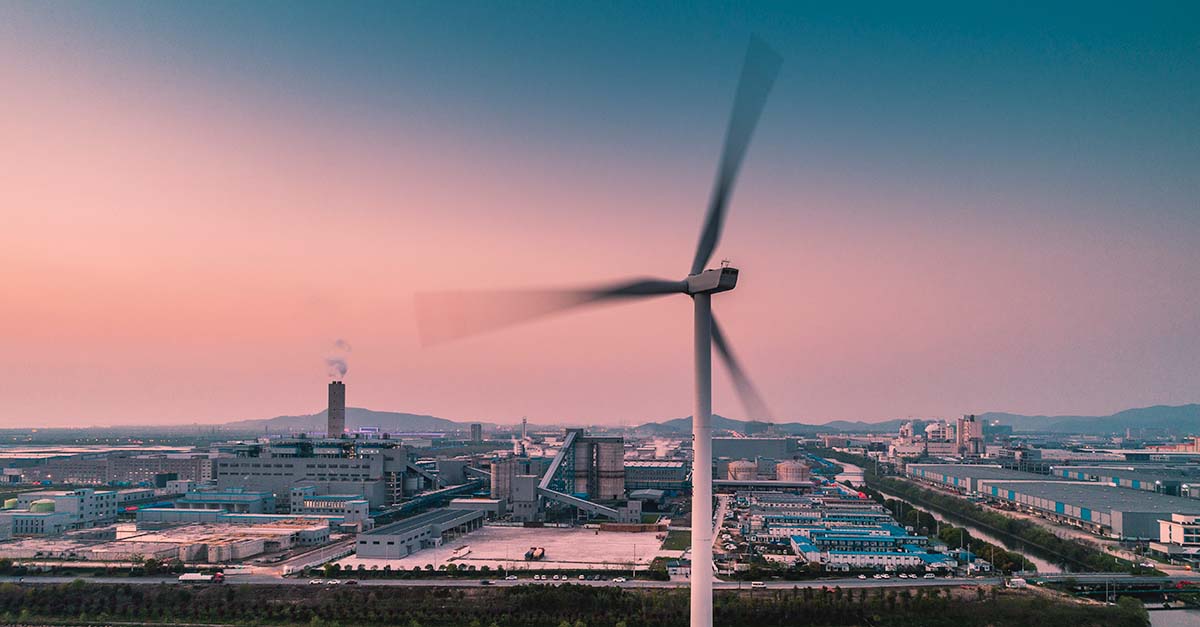 A windmill overlooking an industrial center